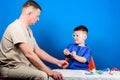 Boy cute child and his father doctor. Hospital worker. Medicine concept. Kid little doctor sit table medical tools