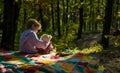 Boy cute child play with teddy bear toy forest background. Child took favorite toy to nature. Picnic with teddy bear