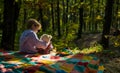 Boy cute child play with teddy bear toy forest background. Child took favorite toy to nature. Picnic with teddy bear Royalty Free Stock Photo