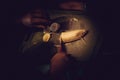 The boy cut bananas with a knife on the table, dark underexposed scene Royalty Free Stock Photo