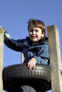 Boy cvlimbing a tyre tower Royalty Free Stock Photo