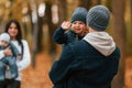 Boy is on the dad's hands. Father with his son on hands walking with mother that is with toddler Royalty Free Stock Photo
