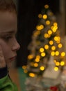 Boy daydreaming with Christmas bokeh lights Royalty Free Stock Photo