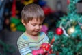 The boy decorates the Christmas tree. Children in Xmas Royalty Free Stock Photo