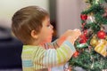 The boy decorates the Christmas tree. Children in Xmas Royalty Free Stock Photo