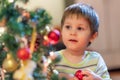 The boy decorates the Christmas tree. Children in Xmas Royalty Free Stock Photo