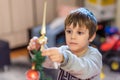 The boy decorates the Christmas tree. Children in Xmas Royalty Free Stock Photo