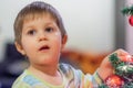 The boy decorates the Christmas tree. Children in Xmas Royalty Free Stock Photo