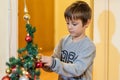 The boy decorates the Christmas tree. Children in Xmas Royalty Free Stock Photo