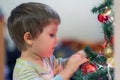 The boy decorates the Christmas tree. Children in Xmas Royalty Free Stock Photo