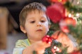 The boy decorates the Christmas tree. Children in Xmas Royalty Free Stock Photo