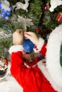 Boy decorates a Christmas tree