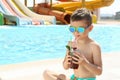 Boy with refreshing drink in water park Royalty Free Stock Photo