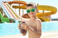 Boy with refreshing drink in water park Royalty Free Stock Photo