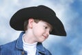 Boy in Denim Jacket and Black Cowboy Hat Royalty Free Stock Photo