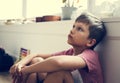 Boy with depression sitting in the room Royalty Free Stock Photo
