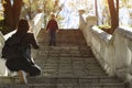 Boy descends stairs to his mother. Walk with baby in park. Naughty child Royalty Free Stock Photo