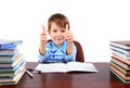 Boy at the desk shows thumbs up Royalty Free Stock Photo