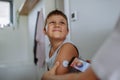 Boy with diabetes checking blood glucose level at home using continuous glucose monitor.