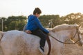 Boy with disabilities having an equine therapy session in equestrian center. Royalty Free Stock Photo