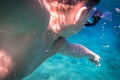 Boy dive in the sea and pointing to fish Royalty Free Stock Photo