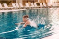 The boy dived into the outdoor pool, splashing Royalty Free Stock Photo