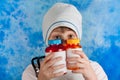 Boy in doctor costume looking out pills bottles