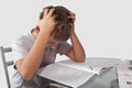 Boy does his homework on a glass table Royalty Free Stock Photo