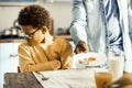 Boy does not want eggs for breakfast, even though his dad insists.