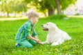 Boy with dog on green grass