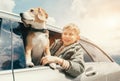 Boy and dog look out from car window Royalty Free Stock Photo