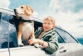 Boy and dog look out from car window Royalty Free Stock Photo