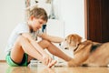 Boy and dog sits on the floor at home Royalty Free Stock Photo