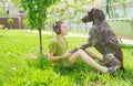 Boy with a dog sitting on grass. Best friends. Happy moments. Listen to music. Earphones listening. Royalty Free Stock Photo