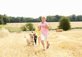 Boy With Dogs Running Through Summer Harvested Fie Royalty Free Stock Photo