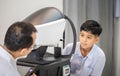 Boy doing eye test checking examination with autorefractor in optical shop, Optometrist doing sight testing for child patient, Eye Royalty Free Stock Photo