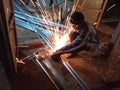 A boy is doing grinding work in a shop in India