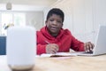 Boy Doing Homework At Home Asking Digital Assistant Question Royalty Free Stock Photo