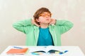 Boy doing homework. Learning difficulties, education concept. Stressed out and tired kid Royalty Free Stock Photo