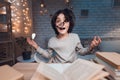 Boy is doing homework for school surrounded by books at night at home. Royalty Free Stock Photo