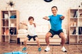 Happy Father and Son do Warm Up Do Squats at Home.