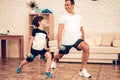 Happy Father and Son Doing Squats in Apartment