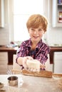 Boy, dough and portrait in kitchen for baking, learning and fun for childhood on holiday indoor. Young child, smile and Royalty Free Stock Photo