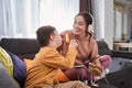 Boy with Down syndrome laughing out loud while his mother playing with him Royalty Free Stock Photo