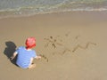 Boy draw on beach Royalty Free Stock Photo