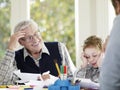 Boy Drawing With Crayons With Father And Grandfather Royalty Free Stock Photo