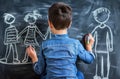 Boy drawing family on chalkboard Royalty Free Stock Photo