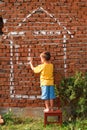 Boy drawing a house Royalty Free Stock Photo