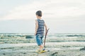 Boy drawing on sand at seaside. Child drawing sand by imaginary on beach for learning Royalty Free Stock Photo