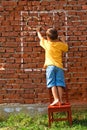 Boy drawing sun and window Royalty Free Stock Photo